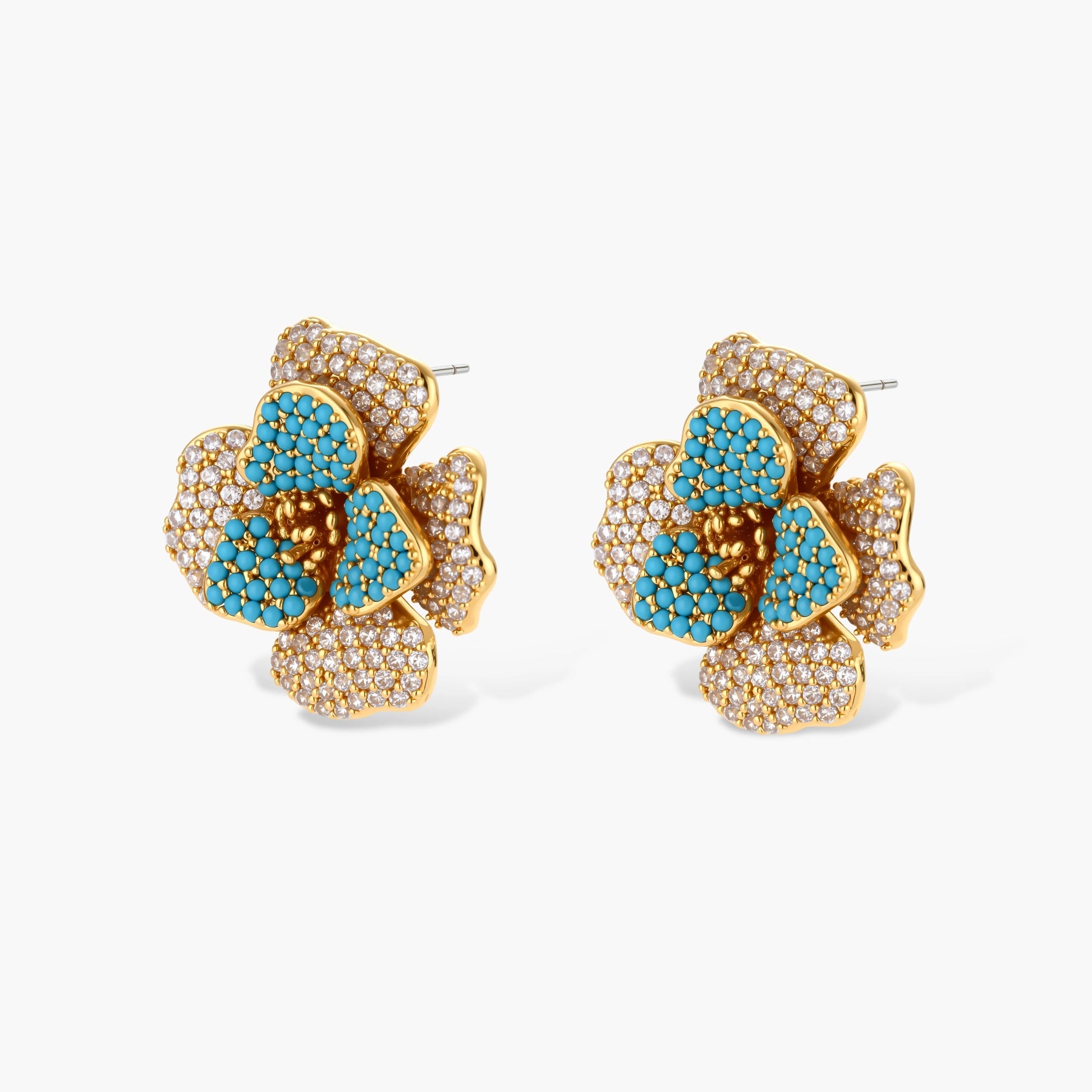 14K gold-plated floral jewelry set with blue cubic zirconia centers and pearl chain details on white background.