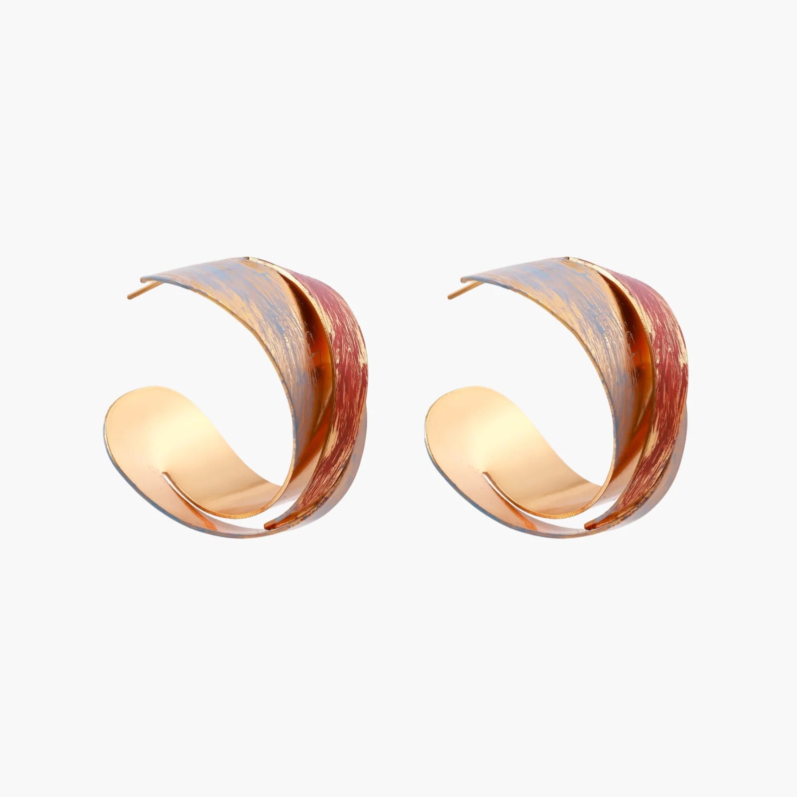 Sculptural gold-plated hoop earrings with diagonal purple and coral enamel stripes in twisted ribbon design