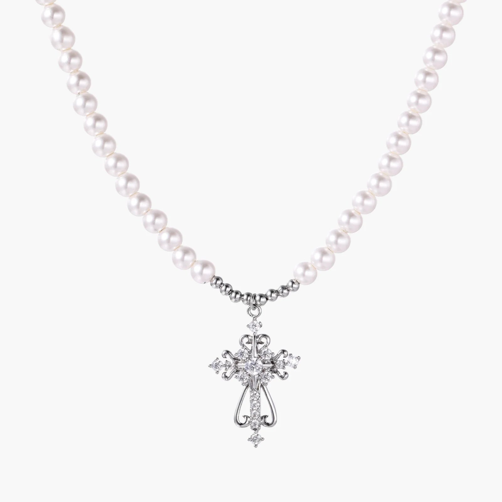 White pearl beaded necklace with ornate crystal-embellished cross pendant on white background, white gold plated finish