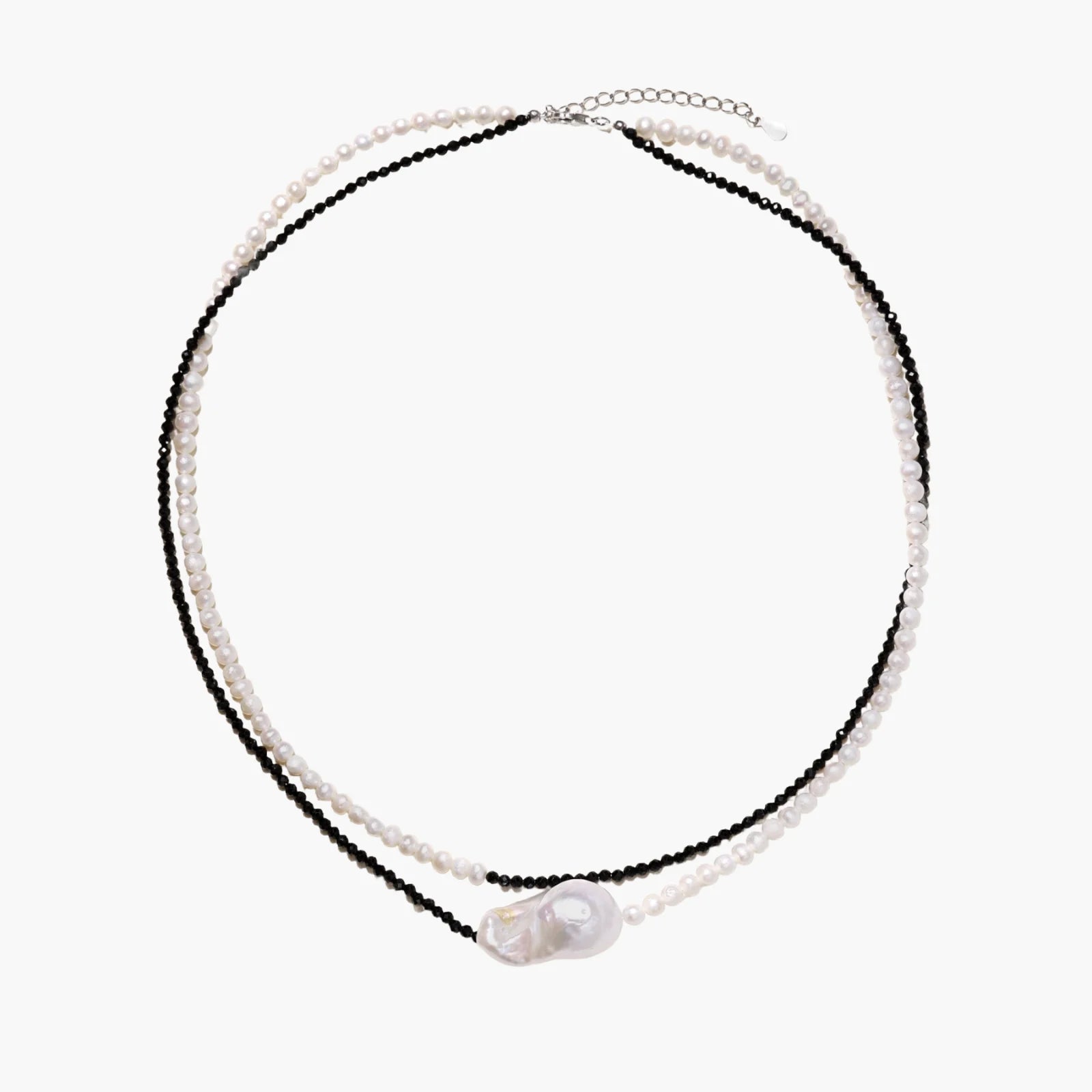 Double-strand necklace with black faceted quartz and white pearls featuring an oversized baroque pearl centerpiece