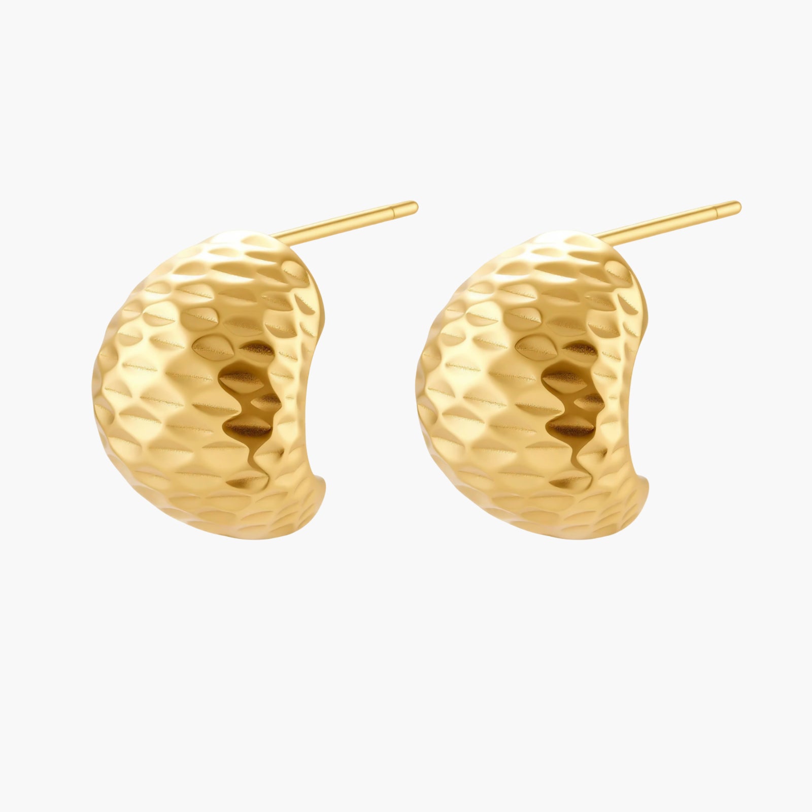 Pair of textured gold-plated sterling silver huggie earrings with dimpled surface finish on cream background.