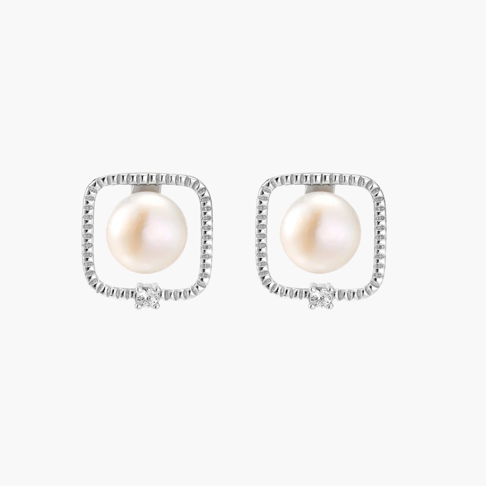 Rhodium-plated silver stud earrings with cushion frame, centered freshwater pearl, and tiny crystal accent
