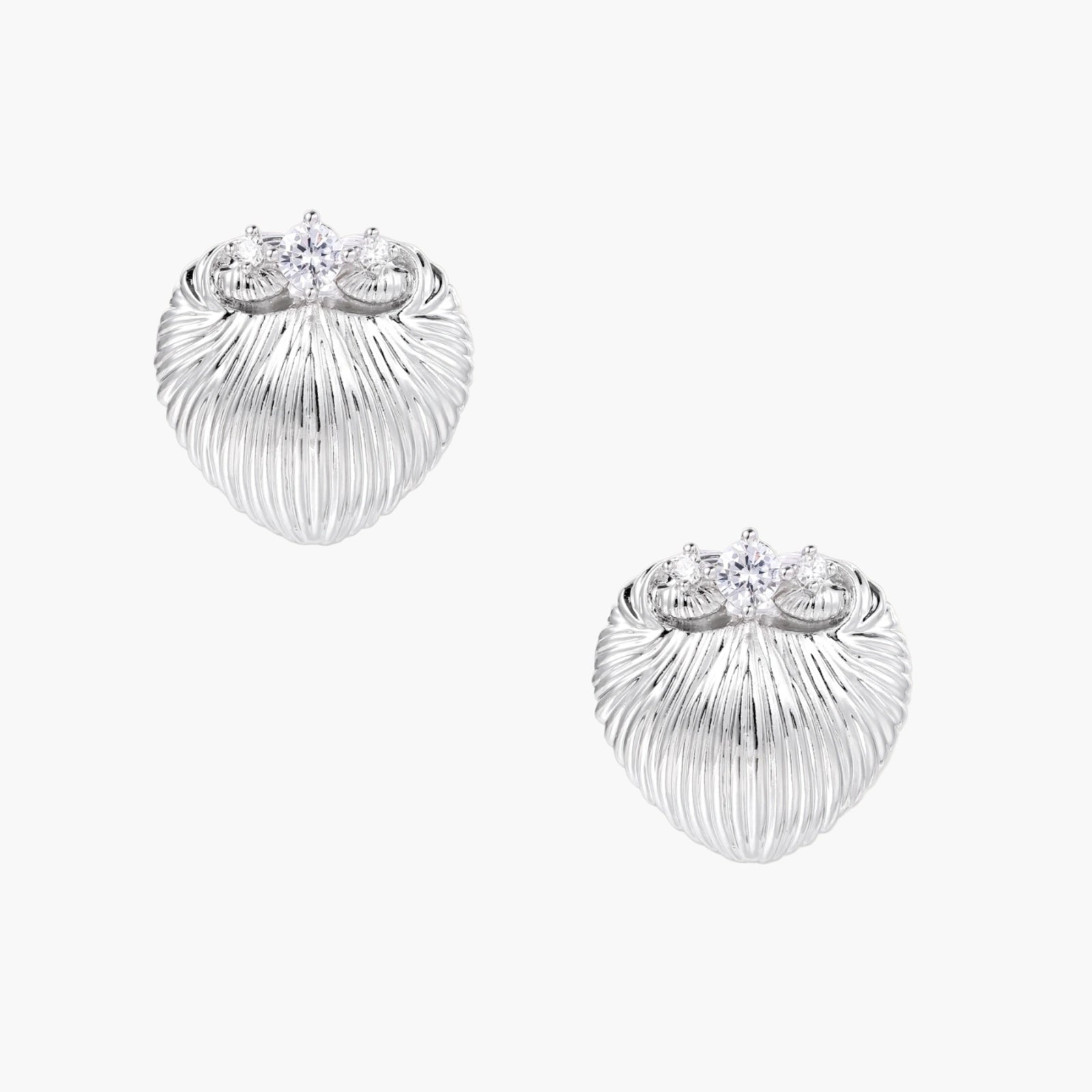 White gold-plated shell-textured stud earrings with three zirconia crystals on ridged surface against cream background.