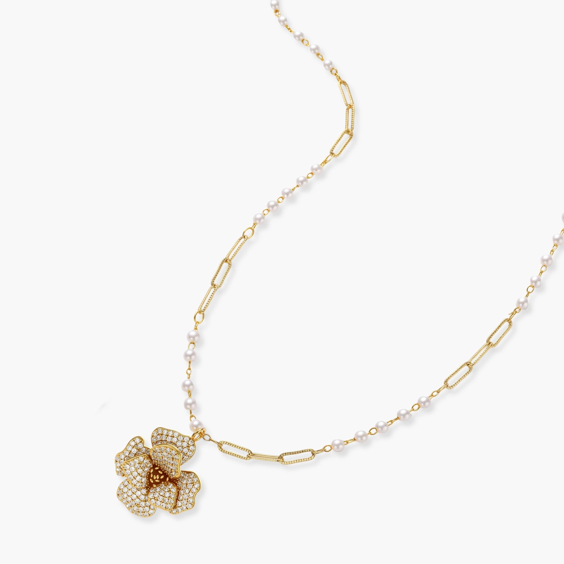 14K gold-plated floral jewelry set with blue cubic zirconia centers and pearl chain details on white background.