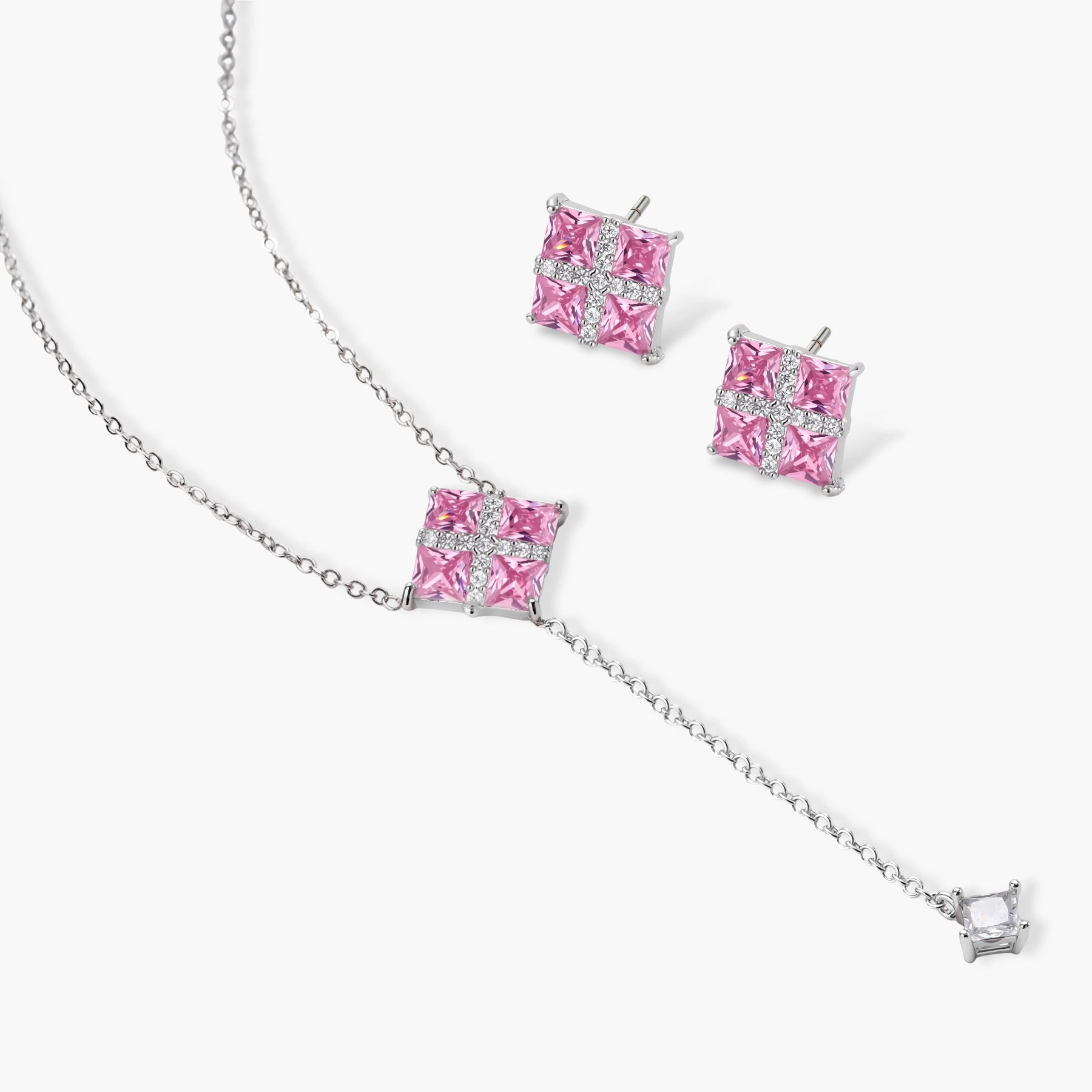 White gold plated jewelry set with pink cubic zirconia stones in geometric cross design, featuring Y-necklace and square stud earrings