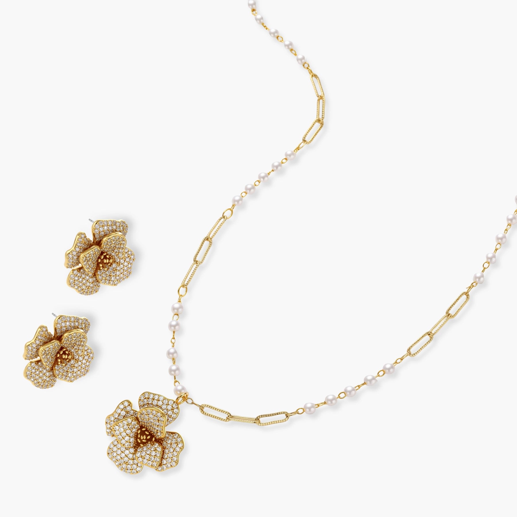 14K gold-plated floral jewelry set with blue cubic zirconia centers and pearl chain details on white background.