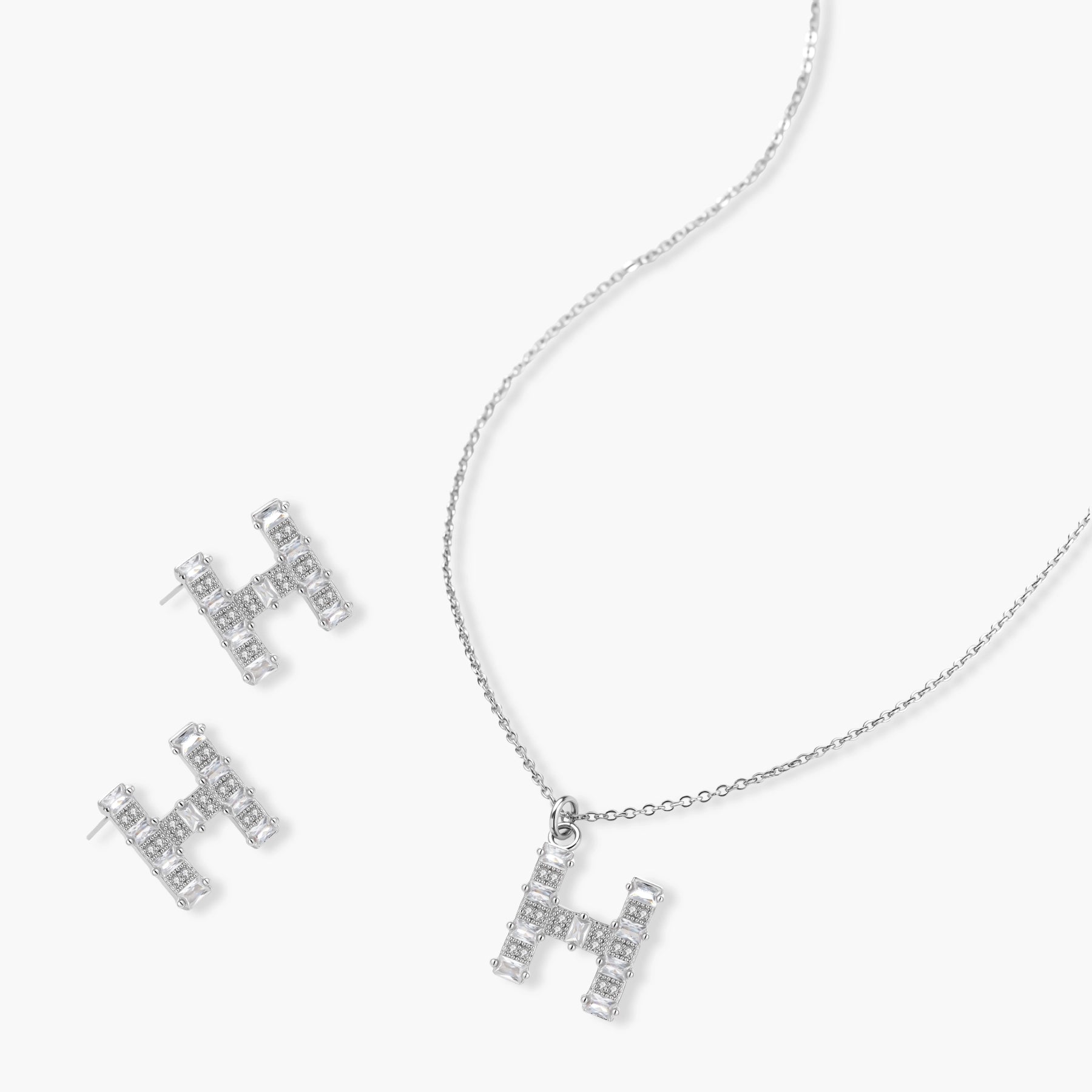 Letter H jewelry set featuring geometric crystal design in gold and white gold plated finish with adjustable chain necklace