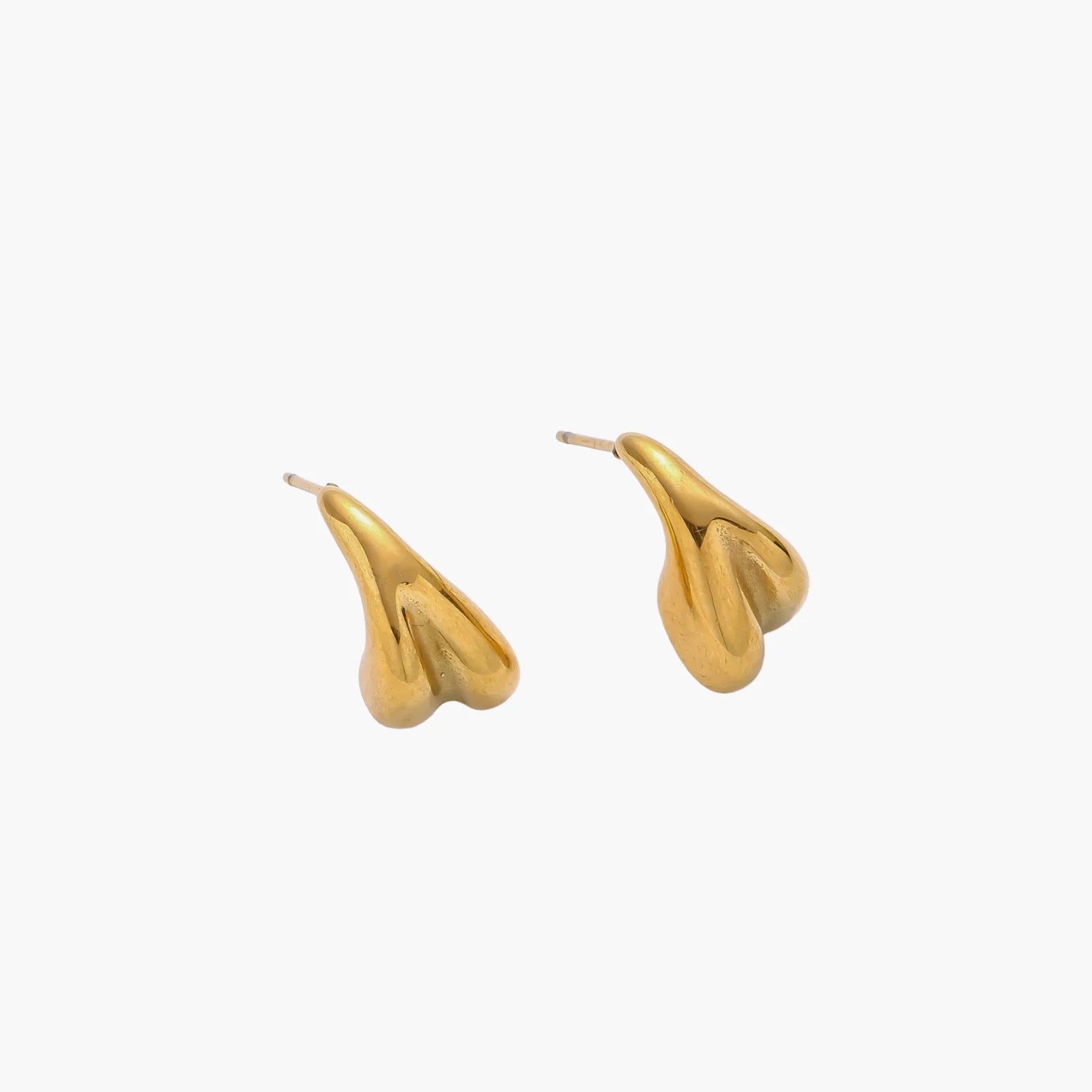 Pair of sculptural gold stud earrings with twisted organic forms on cream background