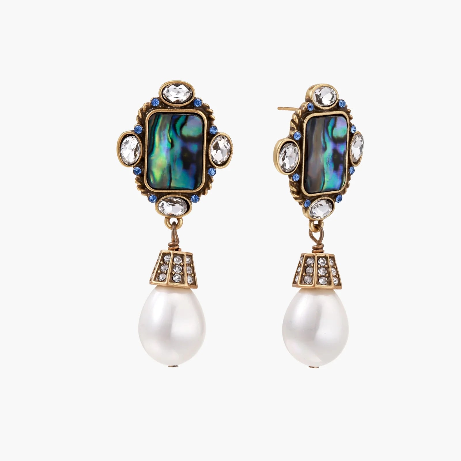 Ornate gold-plated earrings with iridescent abalone shell, crystals, blue stones, and white pearl drops on cream background.