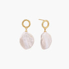 18K gold vermeil twisted circle studs with organic white baroque pearl drops on cream background