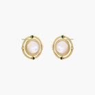 Circular gold stud earrings with iridescent mother-of-pearl center and green zirconia accents on cream background.