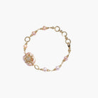 Gold-plated bracelet with pink baroque pearl centerpiece, floral connector, and freshwater pearls
