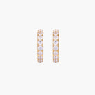 Gold pavé hoop earrings with two freshwater pearls nestled inside the curved design, featuring crystal-studded outer edge.