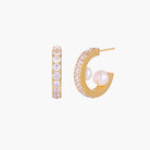 Gold pavé hoop earrings with two freshwater pearls nestled inside the curved design, featuring crystal-studded outer edge.
