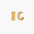 Chunky gold hoops with dimensional ridged texture and 14K plated finish shown in front and side view on cream background.