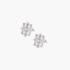 Ornate sterling silver stud earrings with mandala-inspired filigree pattern and four freshwater pearls on beige background