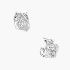 Close-up of sculptural hoop earrings with lattice center band and smooth twisted edges in white gold-plated brass with zirconia