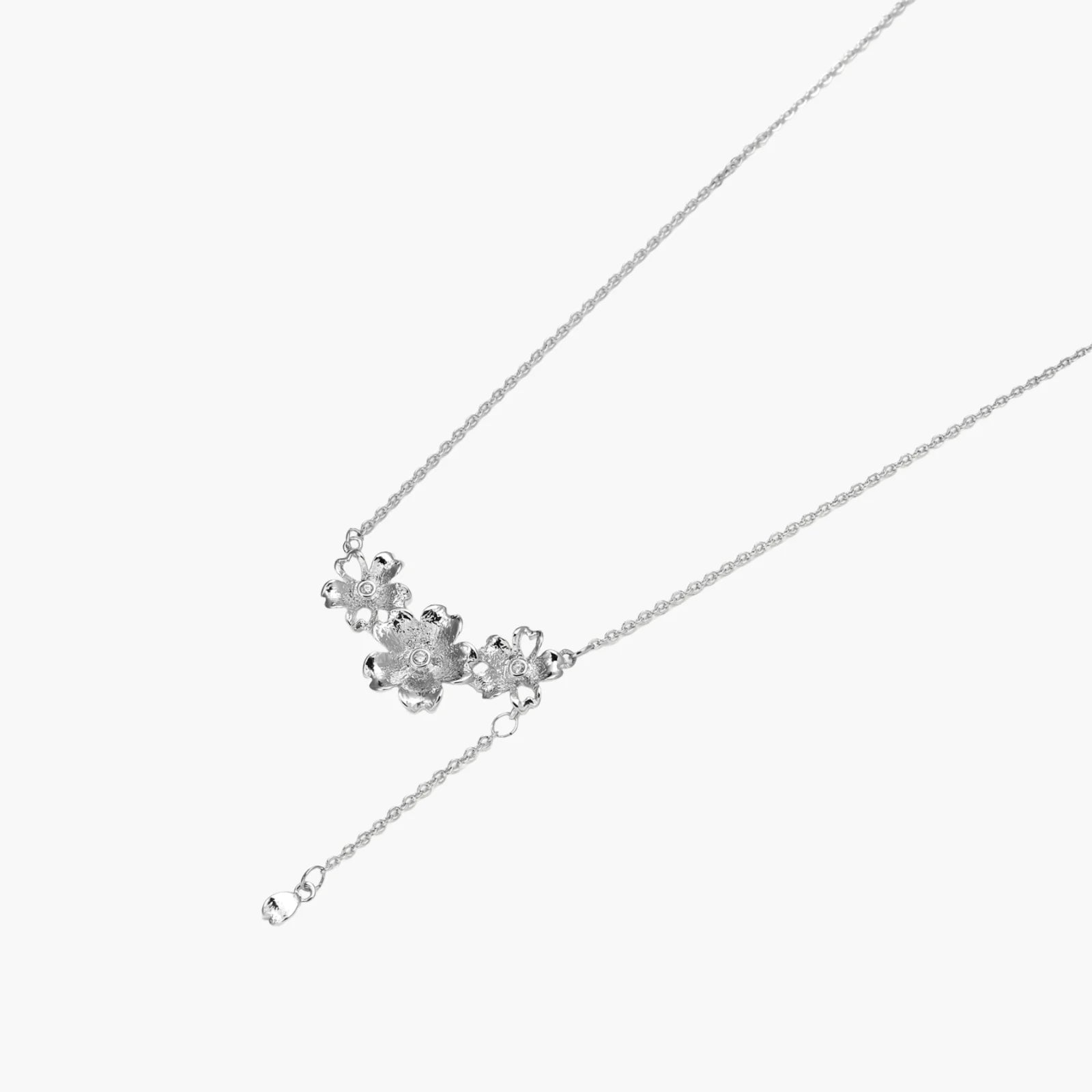 White gold plated Y-shaped necklace with three dimensional flower charms and adjustable drop pendant