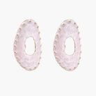 Oval lavender enamel earrings with marbled finish and gold-plated beaded border on cream background.