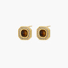 Gold-plated octagonal stud earrings with brown tiger's eye centers and cubic zirconia border on cream background.