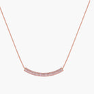 Rose gold jewelry set with pavé cubic zirconia stones including curved necklace, hoop earrings, and adjustable ring on cream background.