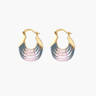 Gold hoop earrings with gradient blue-to-pink enamel in ribbed fan design on beige background